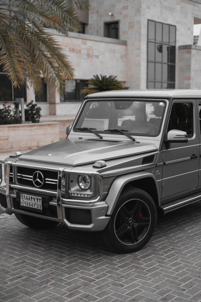 pexels-photo-20534677 Stylish gray Mercedes G-Class SUV parked in modern urban setting.